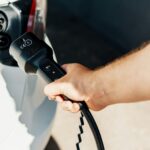 a person is plugging a car with a power cord, Plug-in Hybrid