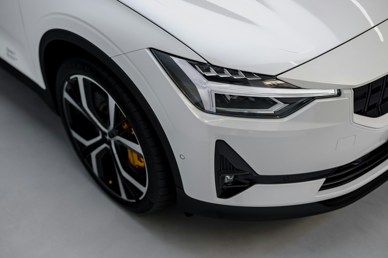 a white car is parked in a garage assicurazione auto Milano