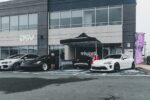 A group of cars parked in front of a building eventi automotive milano