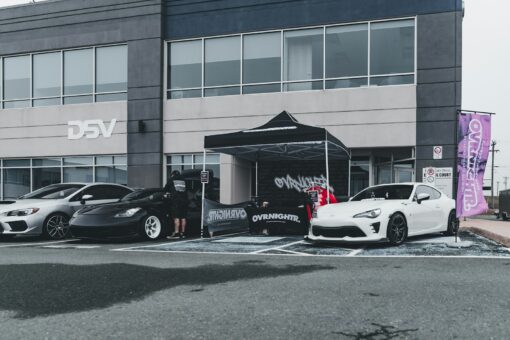 A group of cars parked in front of a building eventi automotive milano