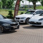 a group of cars parked on a brick road migliori concessionari auto Milano