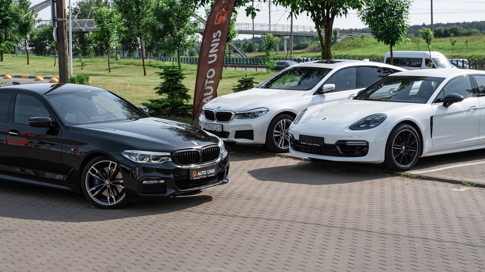 a group of cars parked on a brick road migliori concessionari auto Milano
