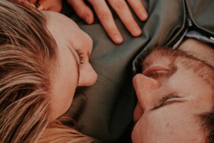 a woman stares into a man's eyes lovingly